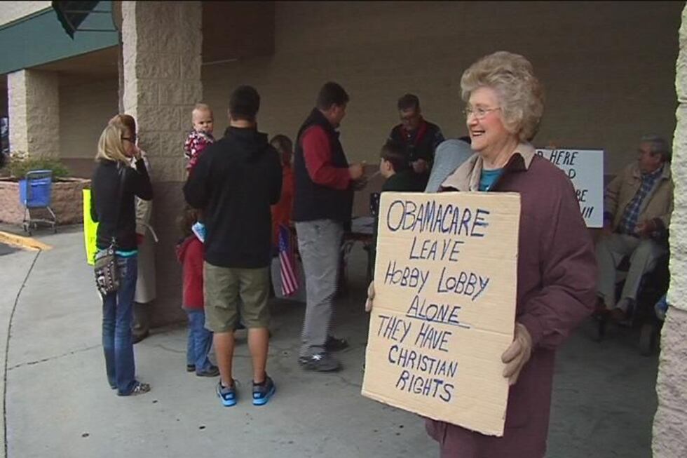 Aquilla King holds a sign supporting Hobby Lobby during "Hobby Lobby Appreciation Day" Saturday.