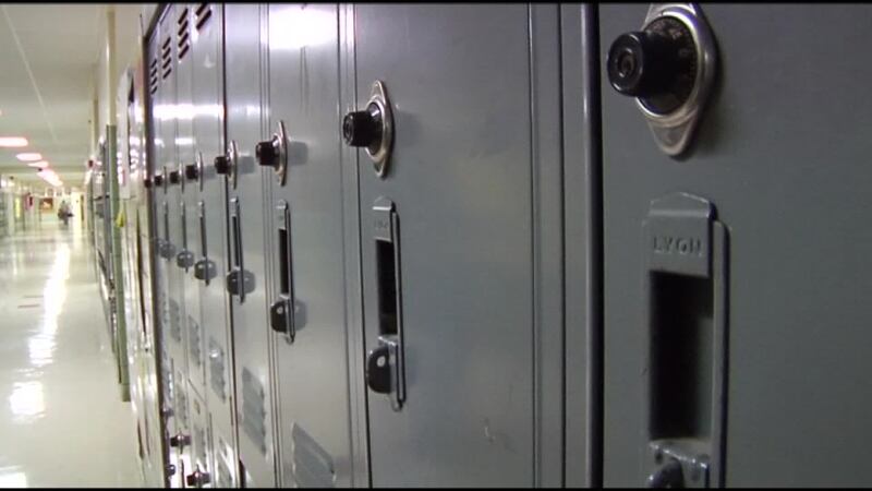 This photo shows a school hallway filled with lockers.