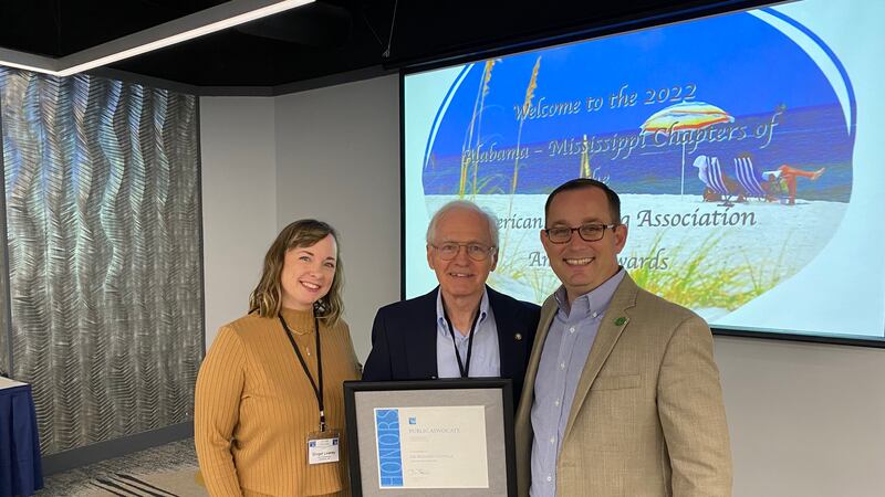 One such award honored Dr. Richard Conville (center), a longtime member of the Planning...