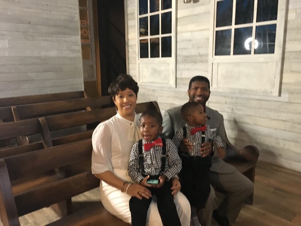 Mt. Helm Missionary Baptist Church Pastor C.J. Rhodes, wife Allison and twin sons pose for...
