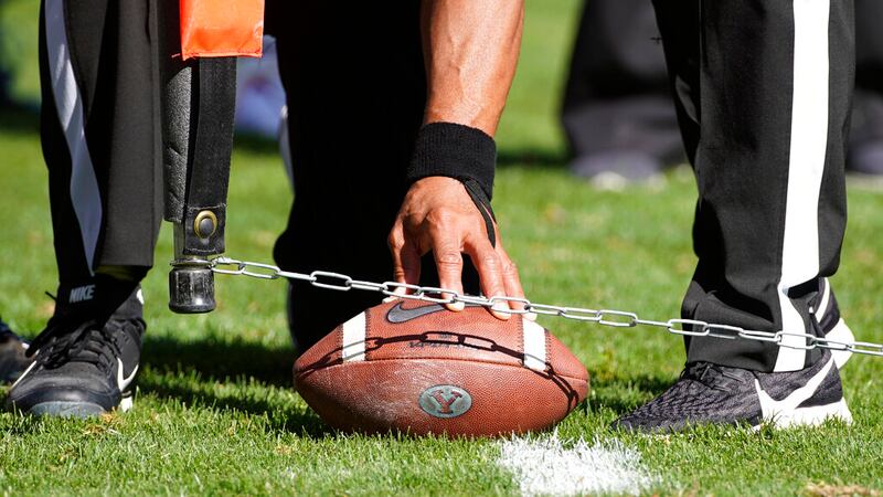 FILE - Officials measure for a first down during an NCAA college football game between USC and...