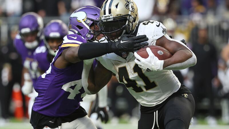 New Orleans Saints running back Alvin Kamara (41) is tackled by Minnesota Vikings safety Josh...