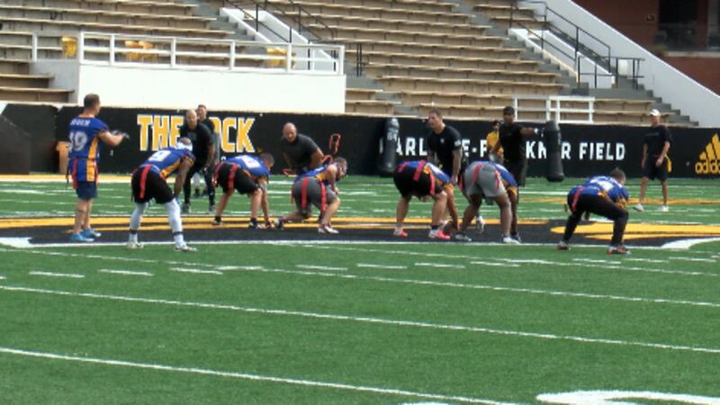 Members of the 177th Armored Brigade line up for the annual "Turkey Bowl" at Southern Miss...