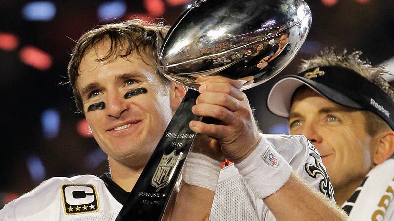 New Orleans Saints quarterback Drew Brees (9) celebrates with the Vince Lombardi Trophy after...